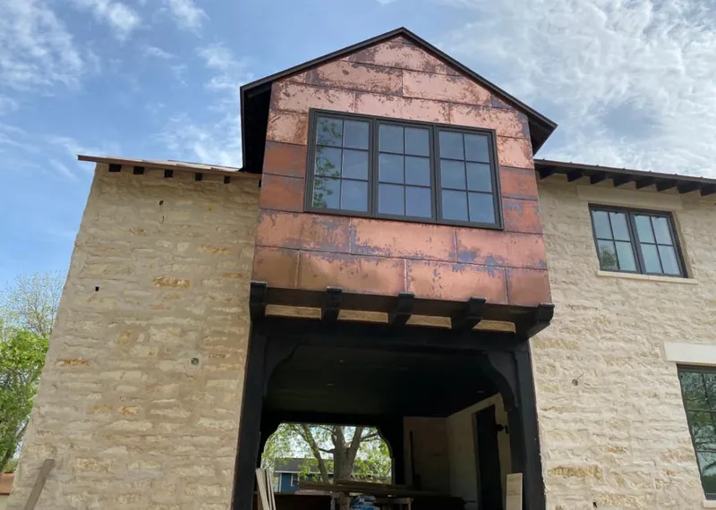 Copper metal panel facade on a stone building for Skylight Installation in Sharon