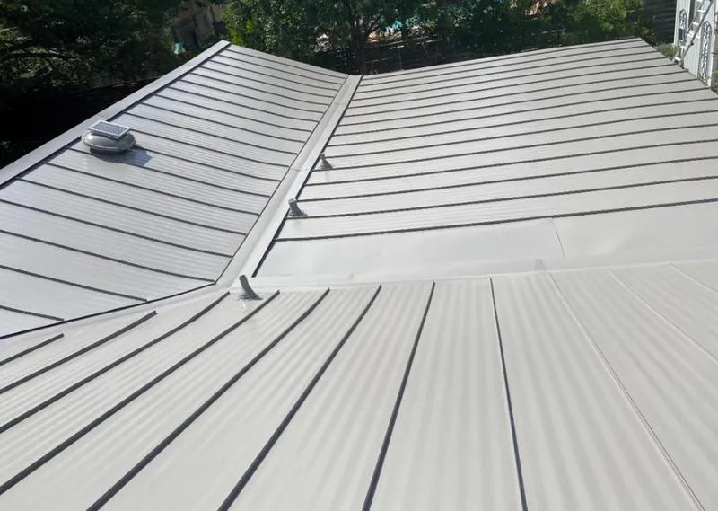 Solar attic fan installed on a metal roof for Roof Ventilation in Sharon